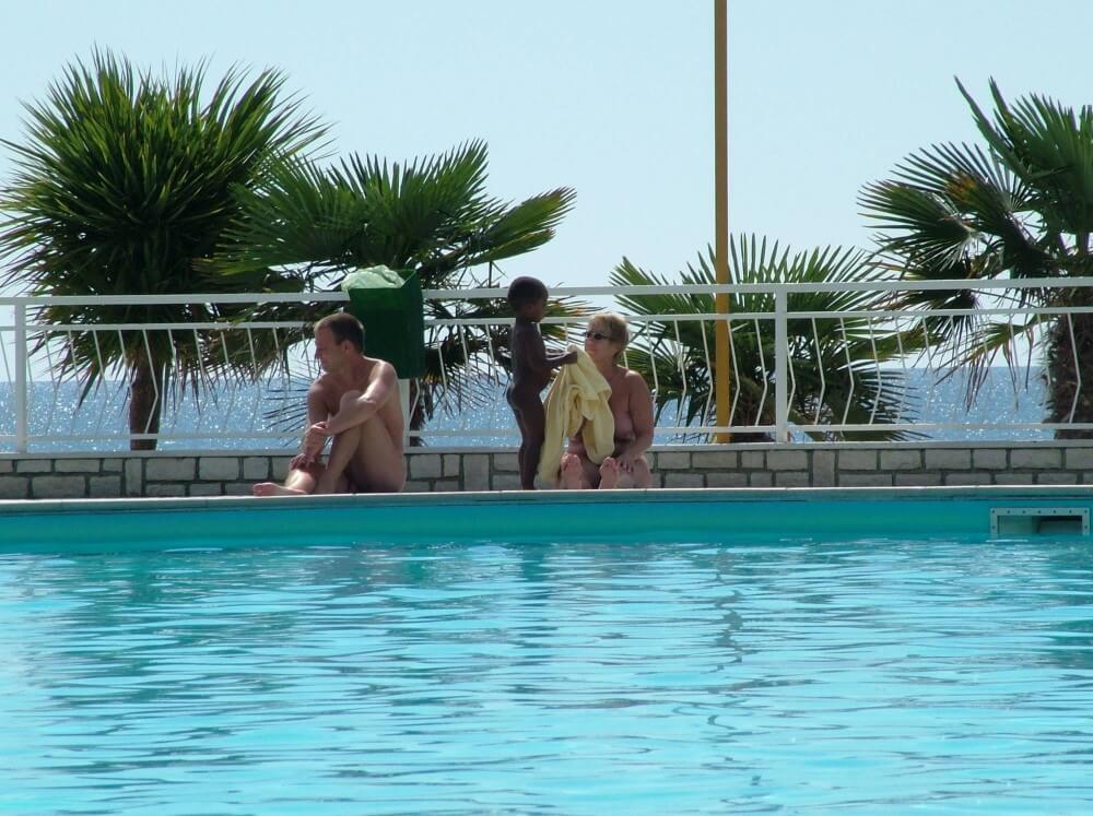 Photo of naturists in an outdoor pool - Naturism helps break free from body stereotypes