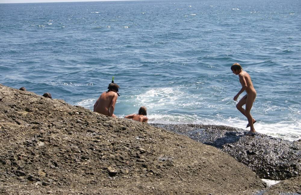 Leaning Against Hit Rocks pics - Active naturists on vacation